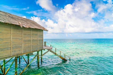 Beautiful water villas in tropical Maldives island at the sunris