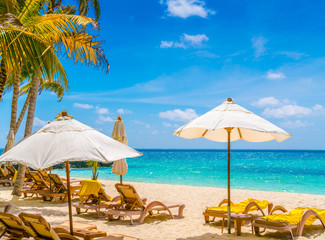 Beach chairs with umbrella at Maldives island, white sandy beach