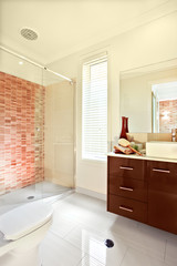 Sunlight spreading inside of a modern bathroom wall and the floo