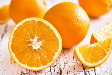 Closeup of halved orange on white rustic wooden background
