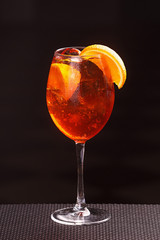 Aperol Spritz in glass, close up on black background