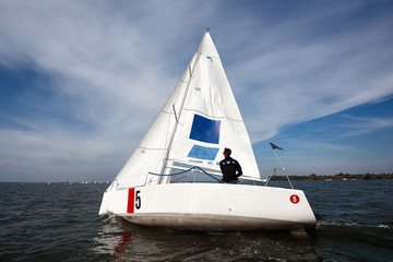 Sailing man on sailboat during regatta. Competition day