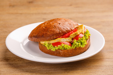 Delicious original american hamburger with grilled beef, bacon and vegetables on white plate, snack or lunch, product photography for restaurant or bistro