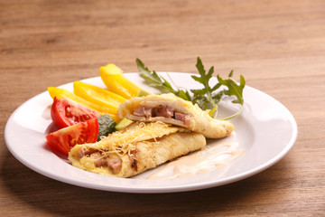 Fried asian egg rolls with pepper ant tomato