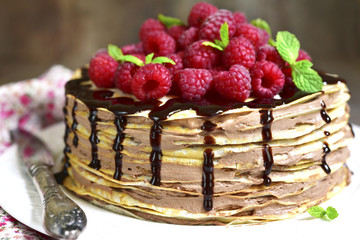 Pancake chocolate cake with fresh raspberry.