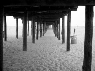 Under the wood jetty on the beach, black and white color