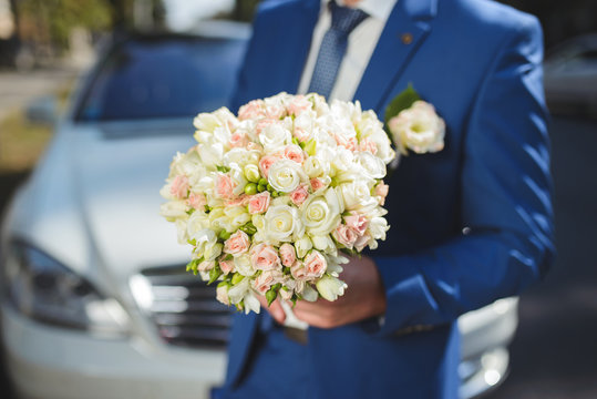 Groom with Flowers at Car