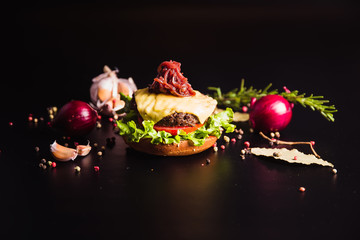Open burger stuffed with a black background