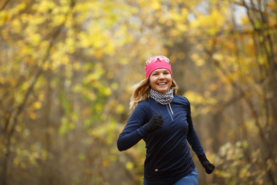 Woman in sneakers among leaves