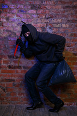 Robber near wall of building