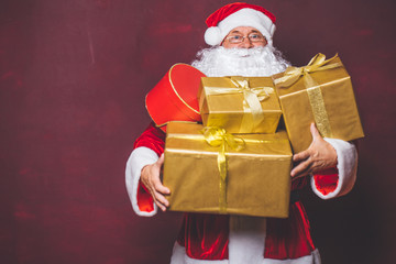 Santa Claus Christmas. Santa holding many Christmas gifts