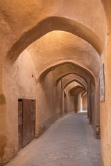 Fototapeta na wymiar Old passage with traditional clay arches in the city of Yazd, Ir