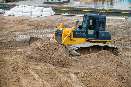 bulldozer conducting excavation works in the pit on a large cons