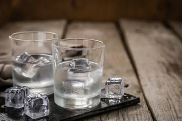Papier Peint photo Lavable Alcool Vodka in shot glasses on rustic wood background