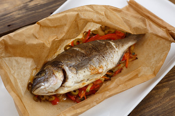 Baked in parchment sleeve fish with a vegetable
