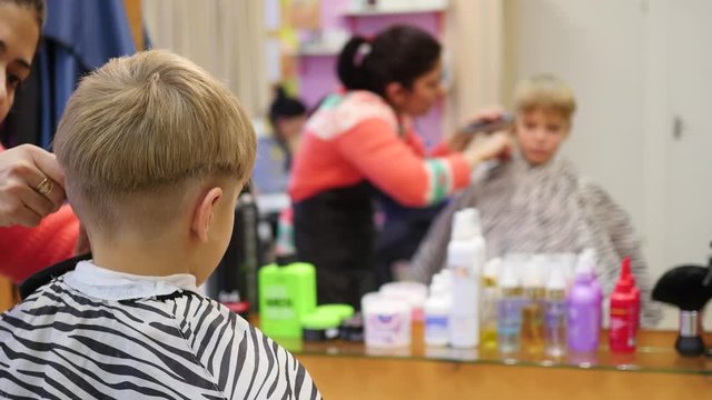 child's haircut at the Barber shop.looking at yourself in the mirror