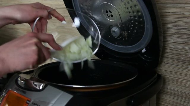 Woman is making food in steamer close-up in the kitchen
