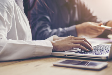 Image of business woman's hands typing in the office.