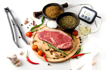 raw steak wooden cutting board spices