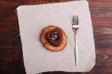 Top view of a chocolate dessert and fork on a wooden table