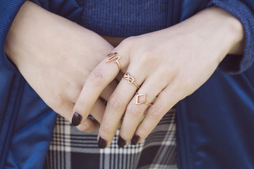 Female hands with collection of hipster golden rings