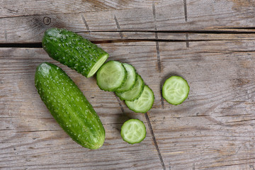 Fresh Cucumber slices on wood background © spaxiax