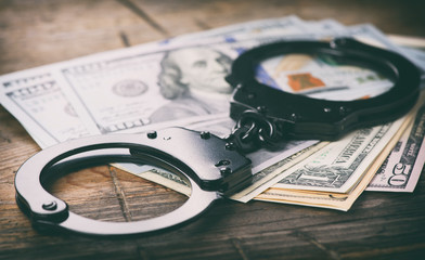Handcuffs on money. Criminal concept