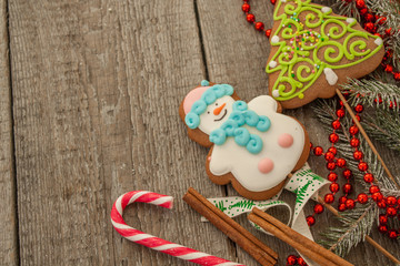 christmas background, composition. spruce branches, gingerbread (Snowman and Christmas tree), cocoa with cream and marshmallows, cinnamon, candy cane.