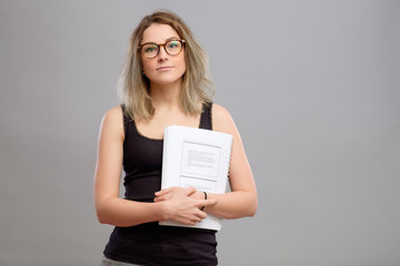 Student girl with glasses holding a book