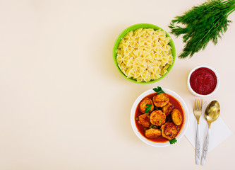 Small meat balls with peas and farfalle. Top view