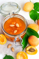 Fresh apricot jam in jar and ripe apricots