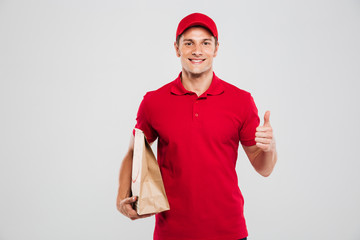 Young delivery man with bag