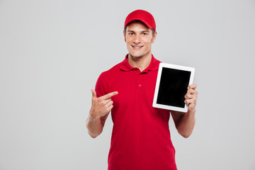 Smiling delivery man with tablet