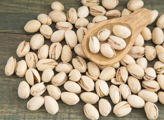 Pistachios in the wooden spoon (Pistacia vera)