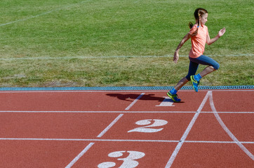 Obraz premium Kids sport, child running on stadium track, training and fitness concept 
