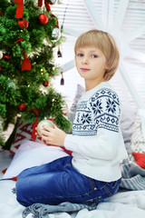 child boy in a winter sweater. The concept of Christmas and New