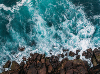 Aerial view of ocean waves and fantastic Rocky coast  - obrazy, fototapety, plakaty