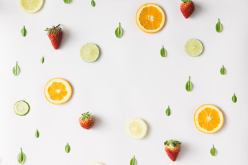 Colorful pattern made of citrus fruits and strawberries. Flat la