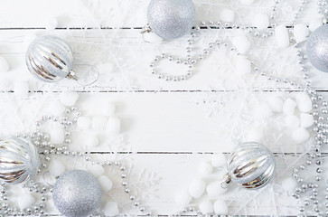 New Year Christmas wooden white background with balls and tinsel
