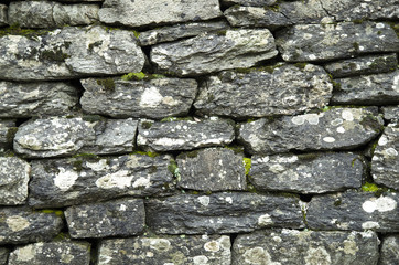 Old wet stone wall closeup