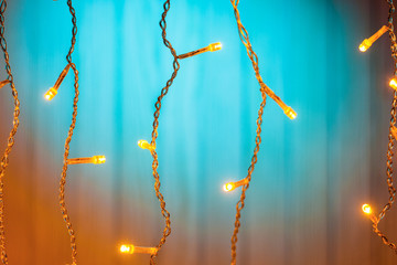 Luminous Christmas garland on a wooden background.