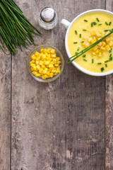 Corn soup in white bowl on wooden background.Copyspace
