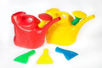 three color plastic watering cans with replaceable nozzles