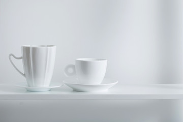 Clean cups on wooden shelf