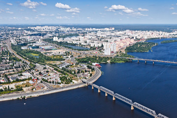 Fototapeta na wymiar Aerial view of the Kiev (Kyiv) city, Ukraine. Dnieper river with bridges. Obolon district in the background