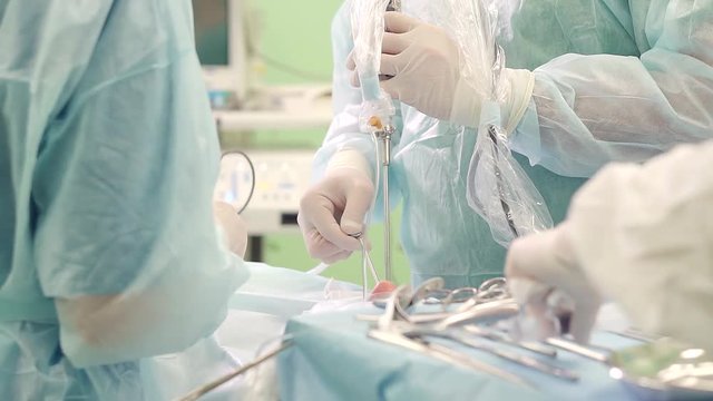 Doctor performs endoscopic surgery removing a brain tumor.
