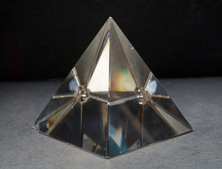 Fototapeta na wymiar Pyramid glass / View of pyramid glass on dark background.