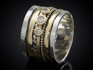 silver ring with gemstone isolated on black background