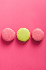 Colorful macaroons cakes on pink background