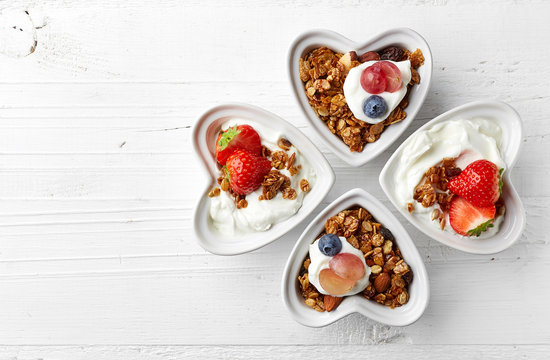 Bowls of granola, yogurt and berries